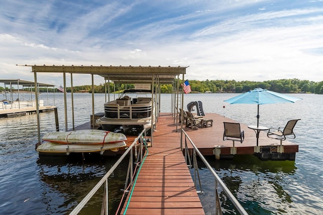 dock area with a water view and boat lift