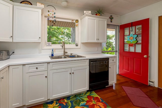 kitchen with dark wood-type flooring, light countertops, black dishwasher, white cabinetry, and a sink