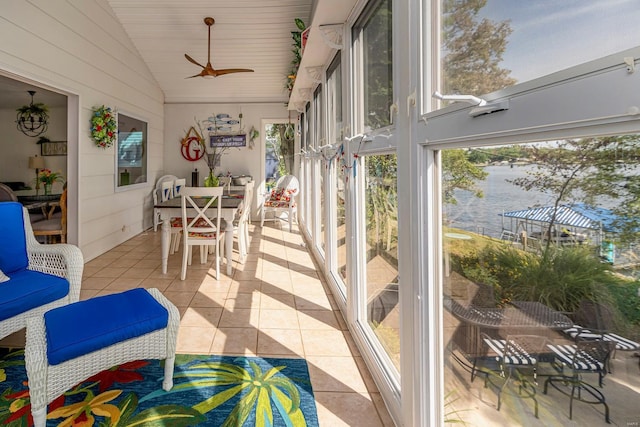 sunroom featuring vaulted ceiling and a ceiling fan