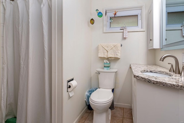 bathroom with vanity, baseboards, tile patterned flooring, curtained shower, and toilet