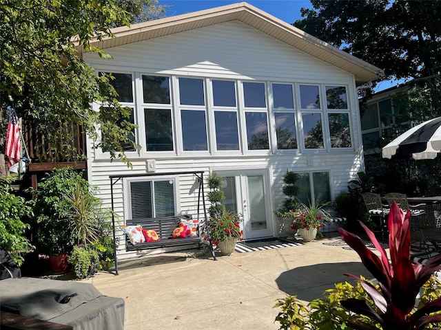 rear view of house featuring a patio and french doors