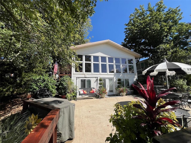 back of house featuring a sunroom and a patio area