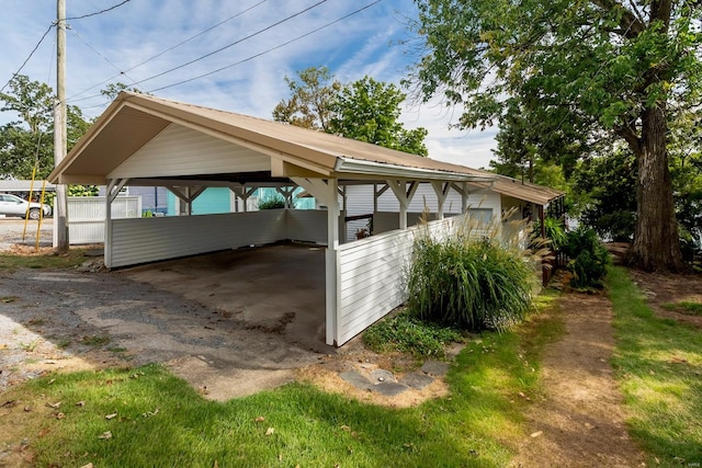 view of side of property with metal roof and a detached carport