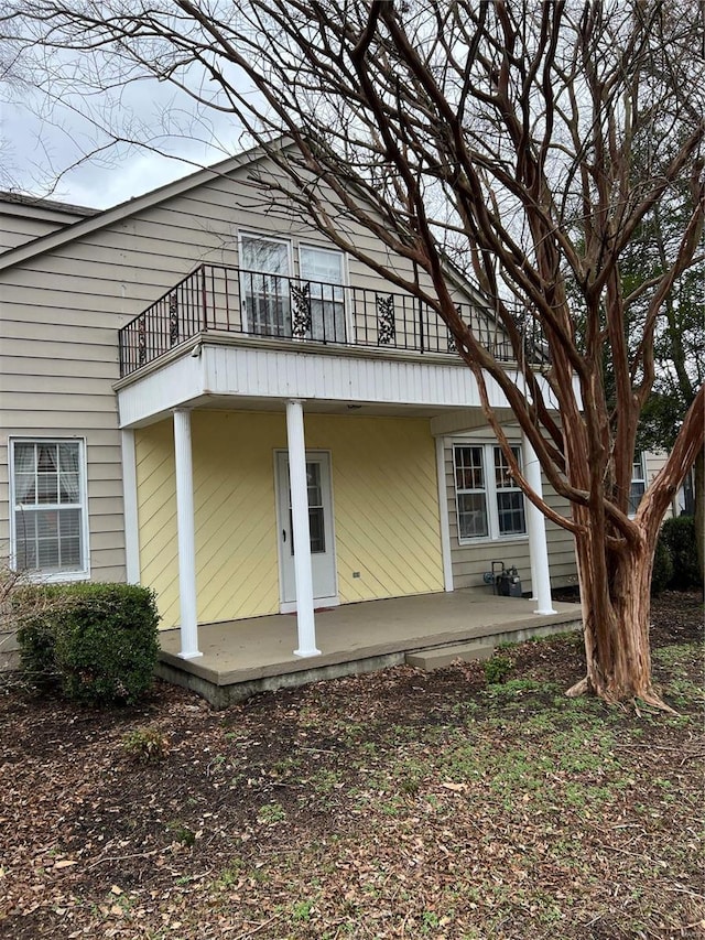 rear view of house featuring a balcony