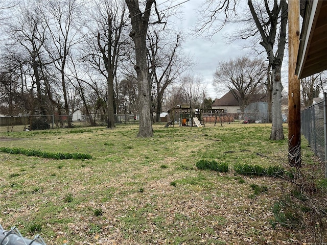 view of yard with a playground and a fenced backyard