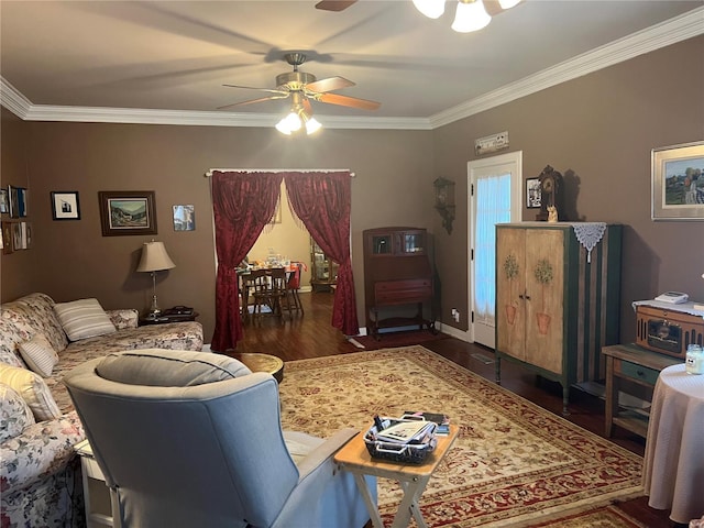 living area with a ceiling fan, crown molding, baseboards, and wood finished floors