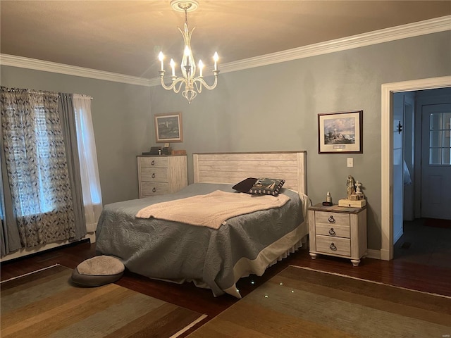 bedroom with an inviting chandelier, crown molding, baseboards, and wood finished floors