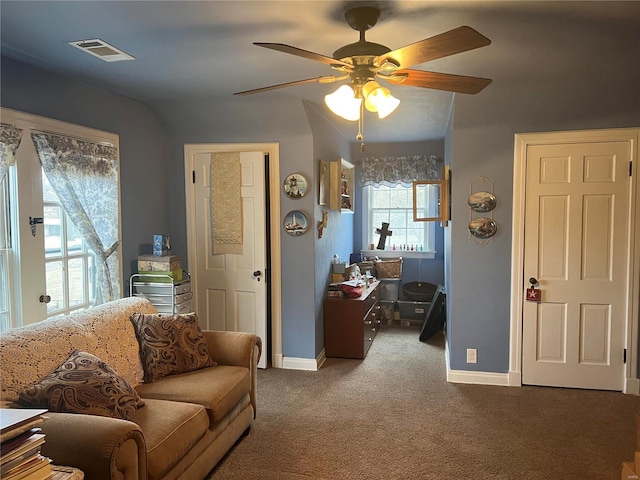 living room featuring carpet, visible vents, ceiling fan, and baseboards