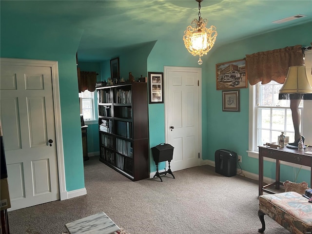 office featuring carpet, visible vents, a chandelier, and baseboards