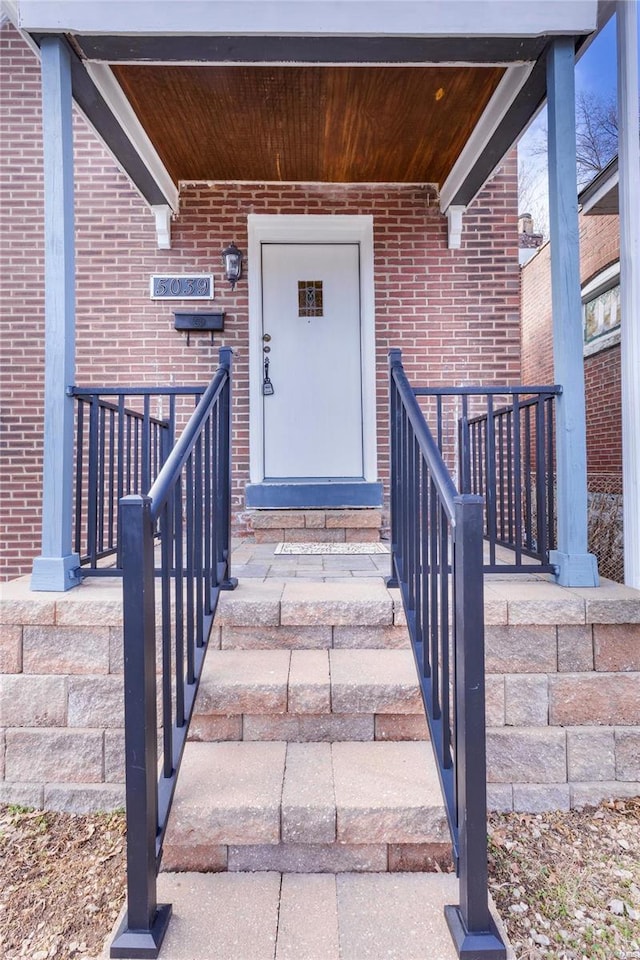 property entrance featuring brick siding