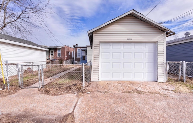 detached garage with a gate and fence