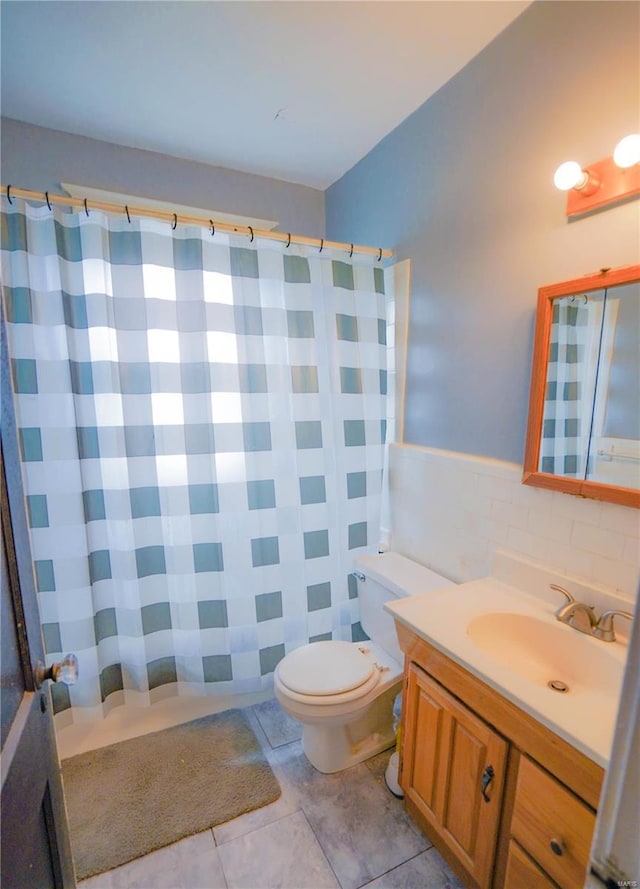 full bathroom featuring tile walls, toilet, vanity, a shower with curtain, and tile patterned floors