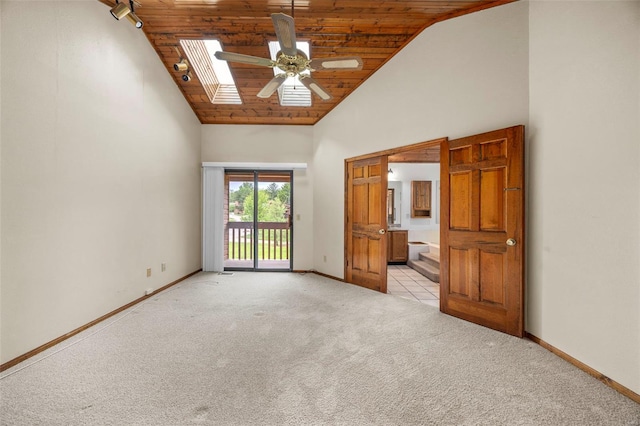 unfurnished bedroom featuring wood ceiling, light colored carpet, baseboards, high vaulted ceiling, and access to outside