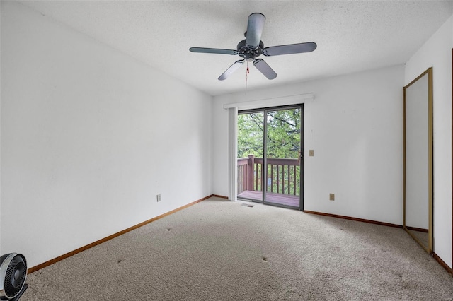 carpeted spare room featuring a ceiling fan, baseboards, visible vents, and a textured ceiling