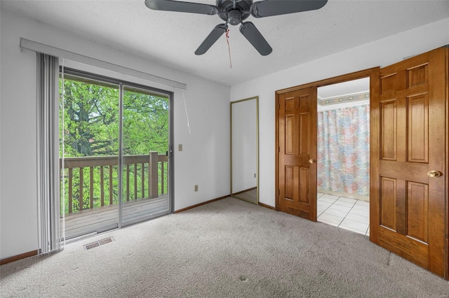 unfurnished bedroom featuring carpet floors, baseboards, visible vents, and access to exterior