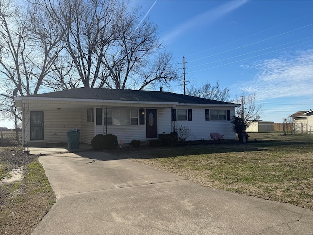 ranch-style home with a front yard and concrete driveway