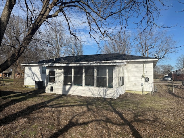 rear view of property featuring a lawn