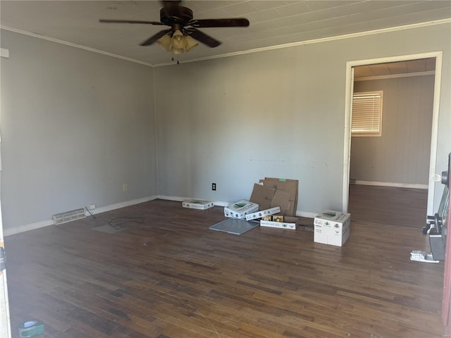 empty room featuring ceiling fan, wood finished floors, visible vents, baseboards, and crown molding