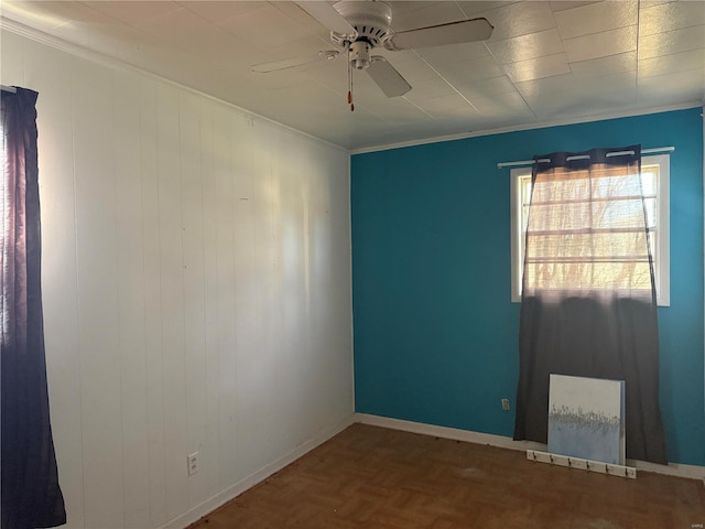 empty room with ceiling fan, baseboards, and crown molding