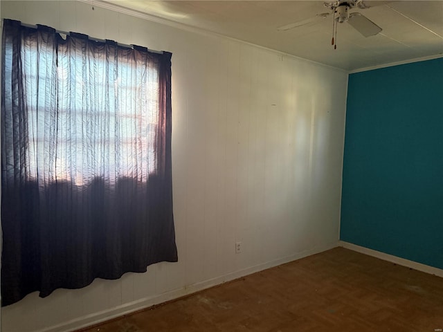 spare room with crown molding, ceiling fan, and baseboards