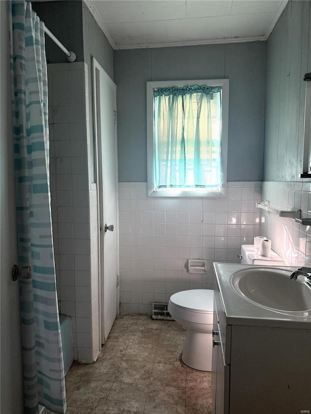 bathroom featuring shower / bath combination with curtain, vanity, toilet, and tile walls