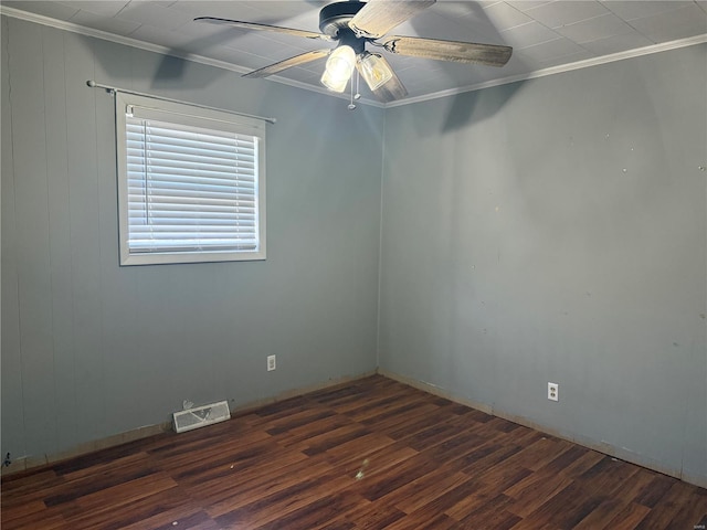 spare room featuring ceiling fan, visible vents, wood finished floors, and ornamental molding