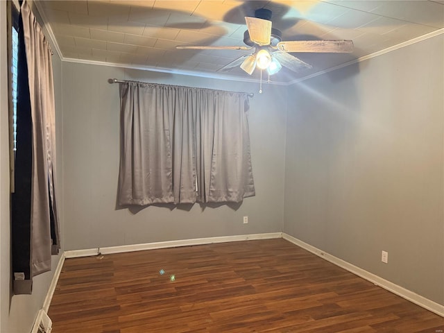 spare room with crown molding, visible vents, a ceiling fan, wood finished floors, and baseboards