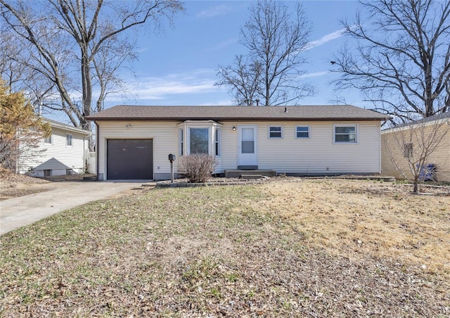 single story home featuring an attached garage, driveway, and a front lawn