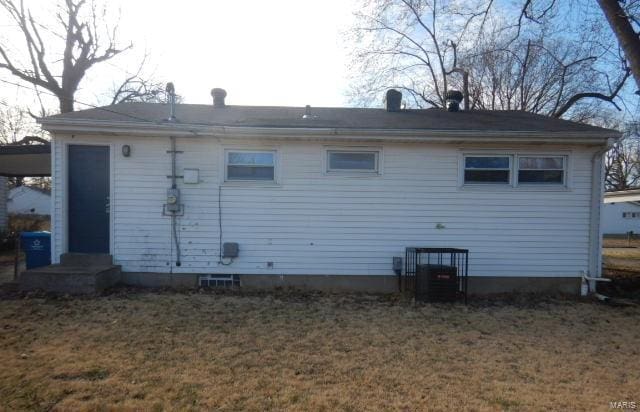 rear view of house with a lawn