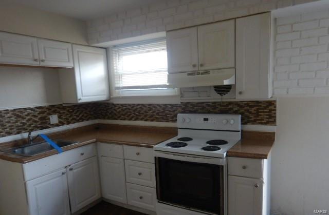 kitchen featuring white electric range oven, tasteful backsplash, white cabinets, under cabinet range hood, and a sink