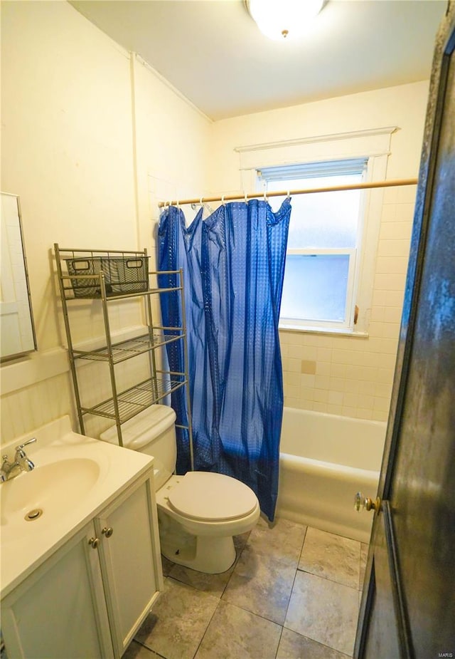 full bathroom featuring toilet, tile patterned floors, shower / tub combo with curtain, and vanity