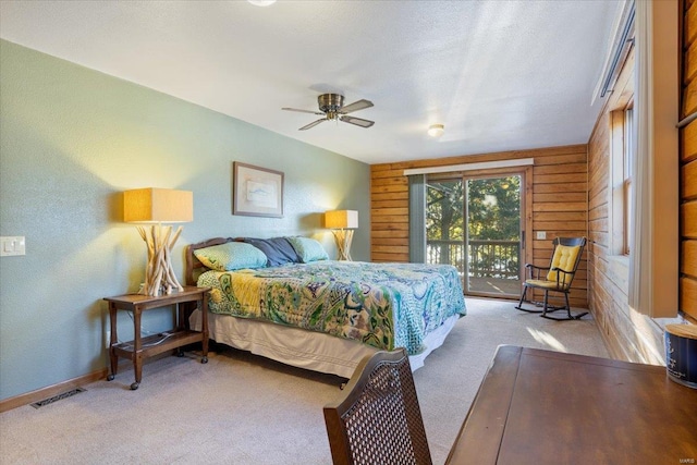 bedroom with access to exterior, visible vents, baseboards, ceiling fan, and carpet flooring