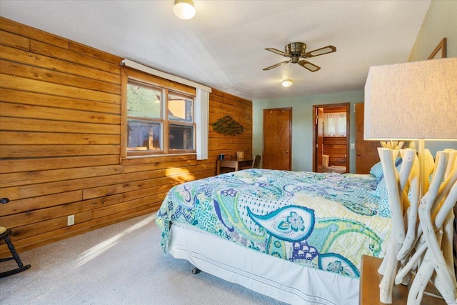 carpeted bedroom featuring wooden walls