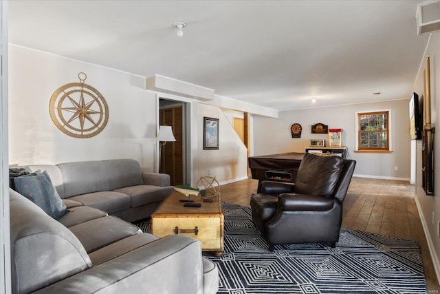 living room with stairway, baseboards, and wood finished floors