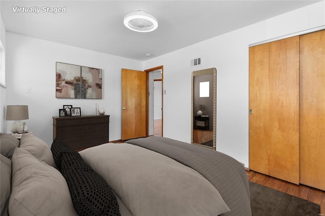 bedroom with wood finished floors and visible vents