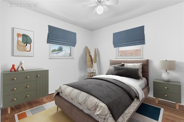 bedroom with ceiling fan and wood finished floors