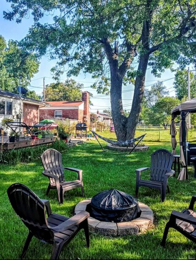 view of yard with an outdoor fire pit and a wooden deck