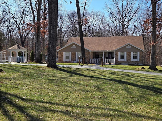 view of front facade with a gazebo, covered porch, and a front lawn