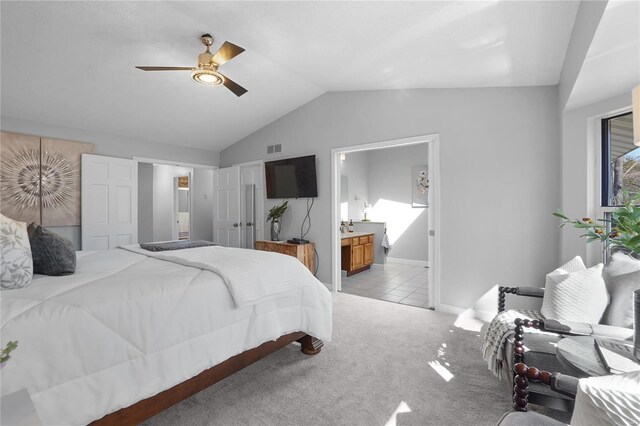 bedroom featuring a ceiling fan, carpet, visible vents, lofted ceiling, and ensuite bathroom