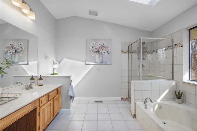 full bath with a garden tub, a shower stall, tile patterned flooring, vanity, and vaulted ceiling