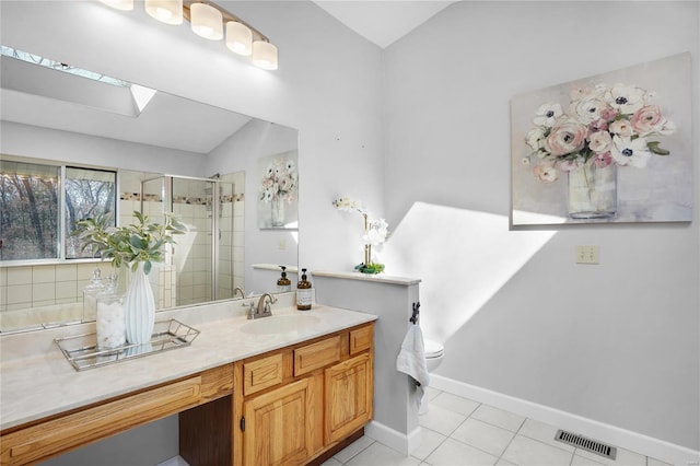 bathroom with visible vents, a shower stall, baseboards, tile patterned floors, and vanity