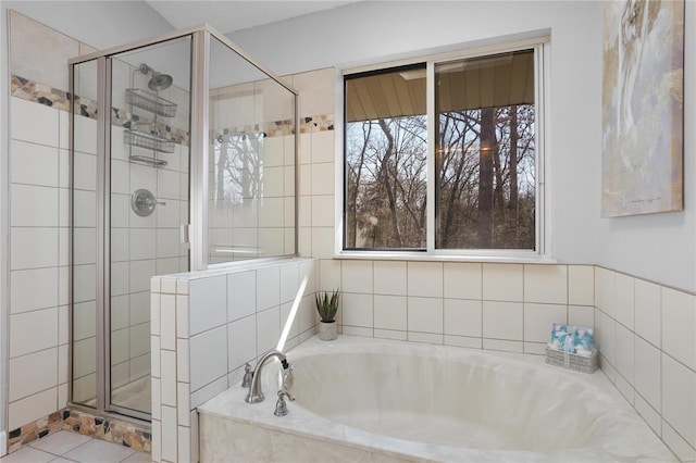 full bathroom featuring a shower stall and a garden tub