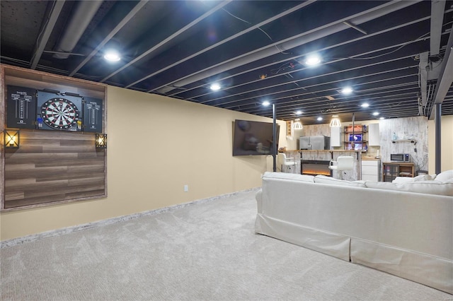 carpeted living room featuring a lit fireplace