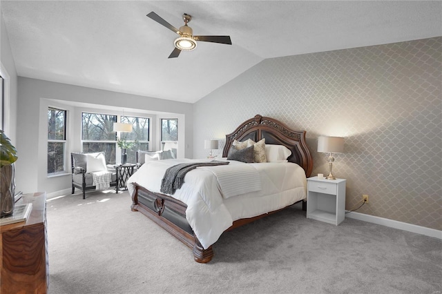 bedroom with baseboards, carpet floors, vaulted ceiling, and wallpapered walls