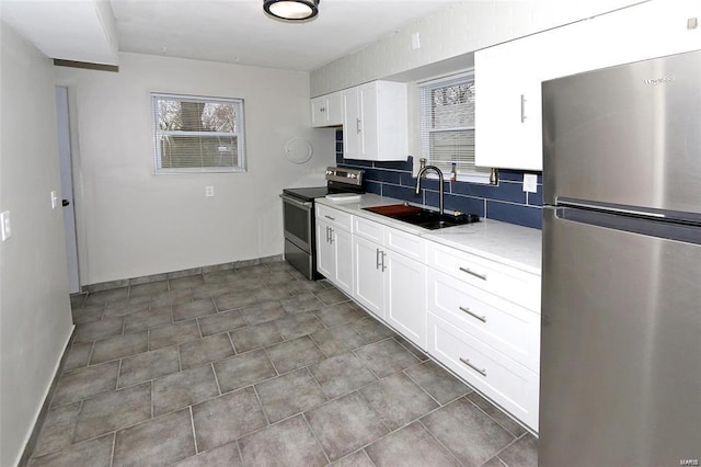 kitchen with plenty of natural light, tasteful backsplash, stainless steel appliances, and a sink