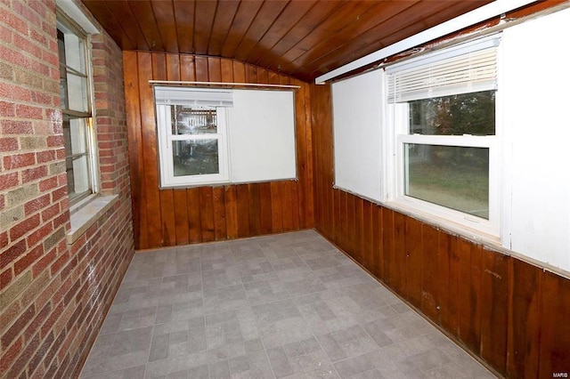 unfurnished sunroom featuring wooden ceiling and vaulted ceiling