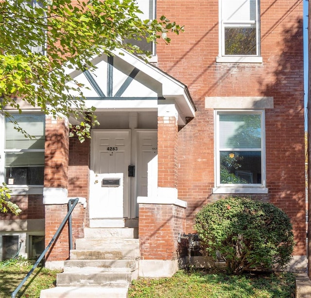 entrance to property with brick siding