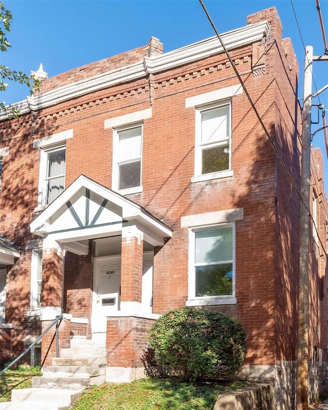 view of property featuring brick siding