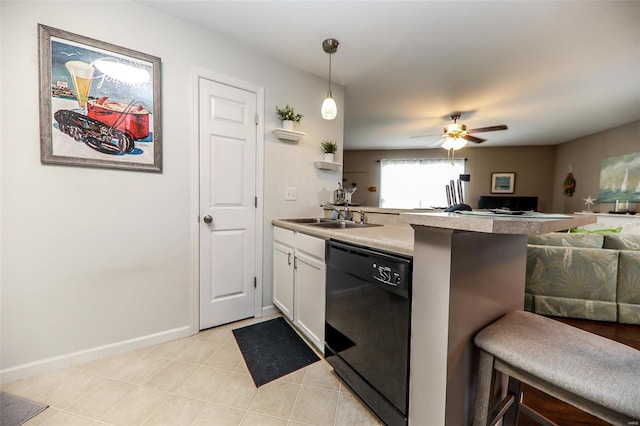 kitchen with a breakfast bar area, a peninsula, a sink, black dishwasher, and open floor plan