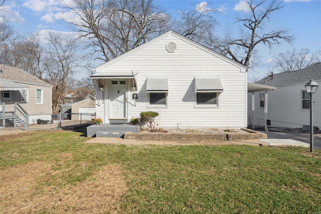 view of front of home with a front yard and fence